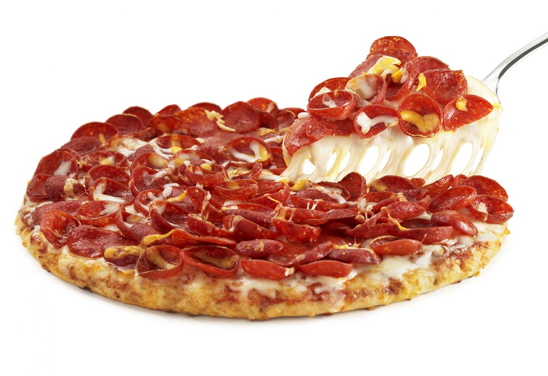 Pepperoni pizza slice getting taken from the whole pizza on a white background.