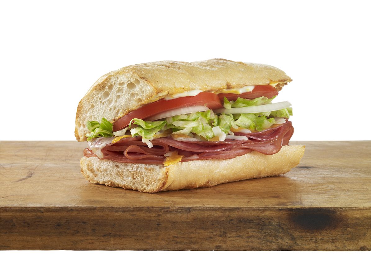 Sandwich on a wooden board on a white background.