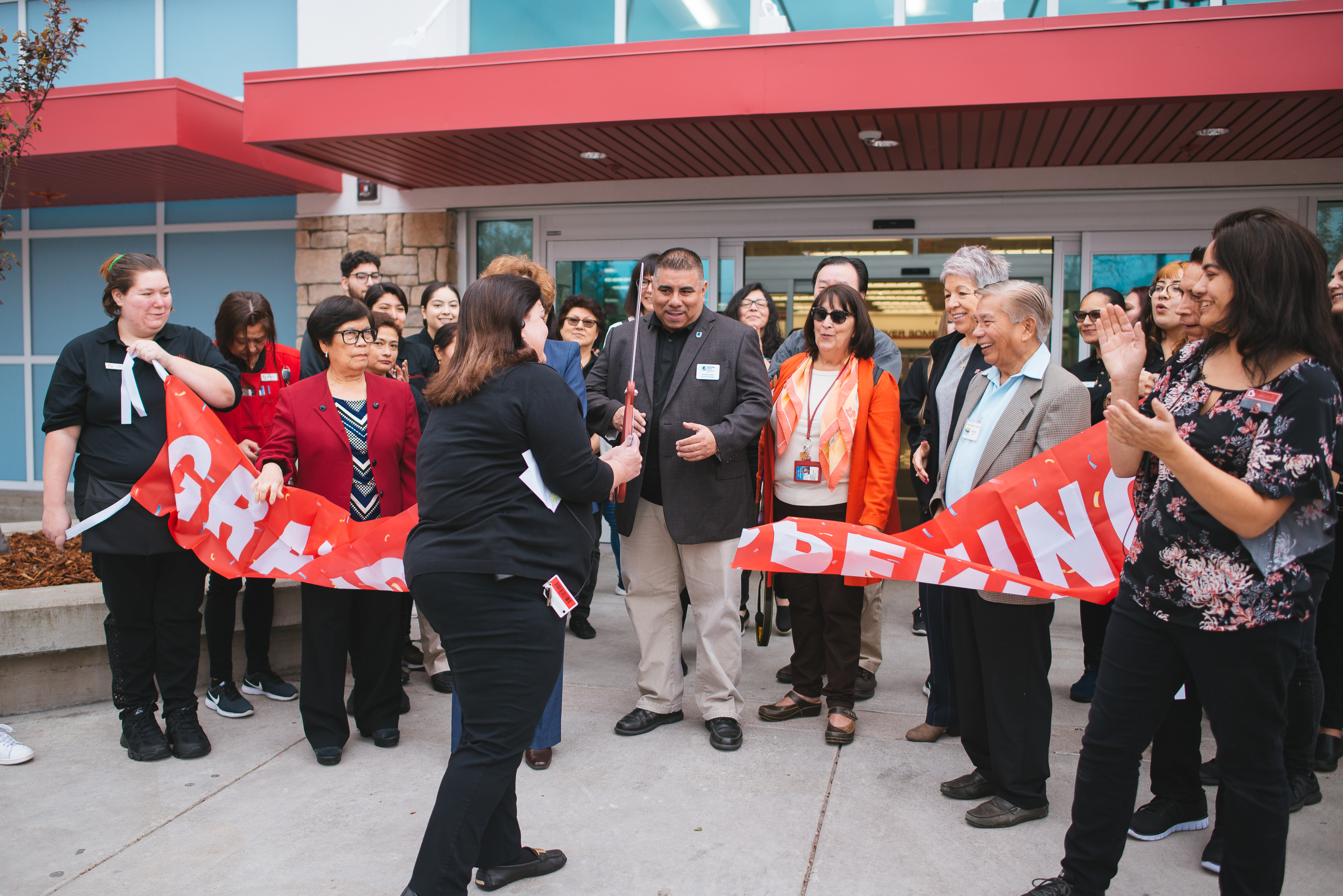Woman doing the ribbon cutting for Burlington's grand opening.