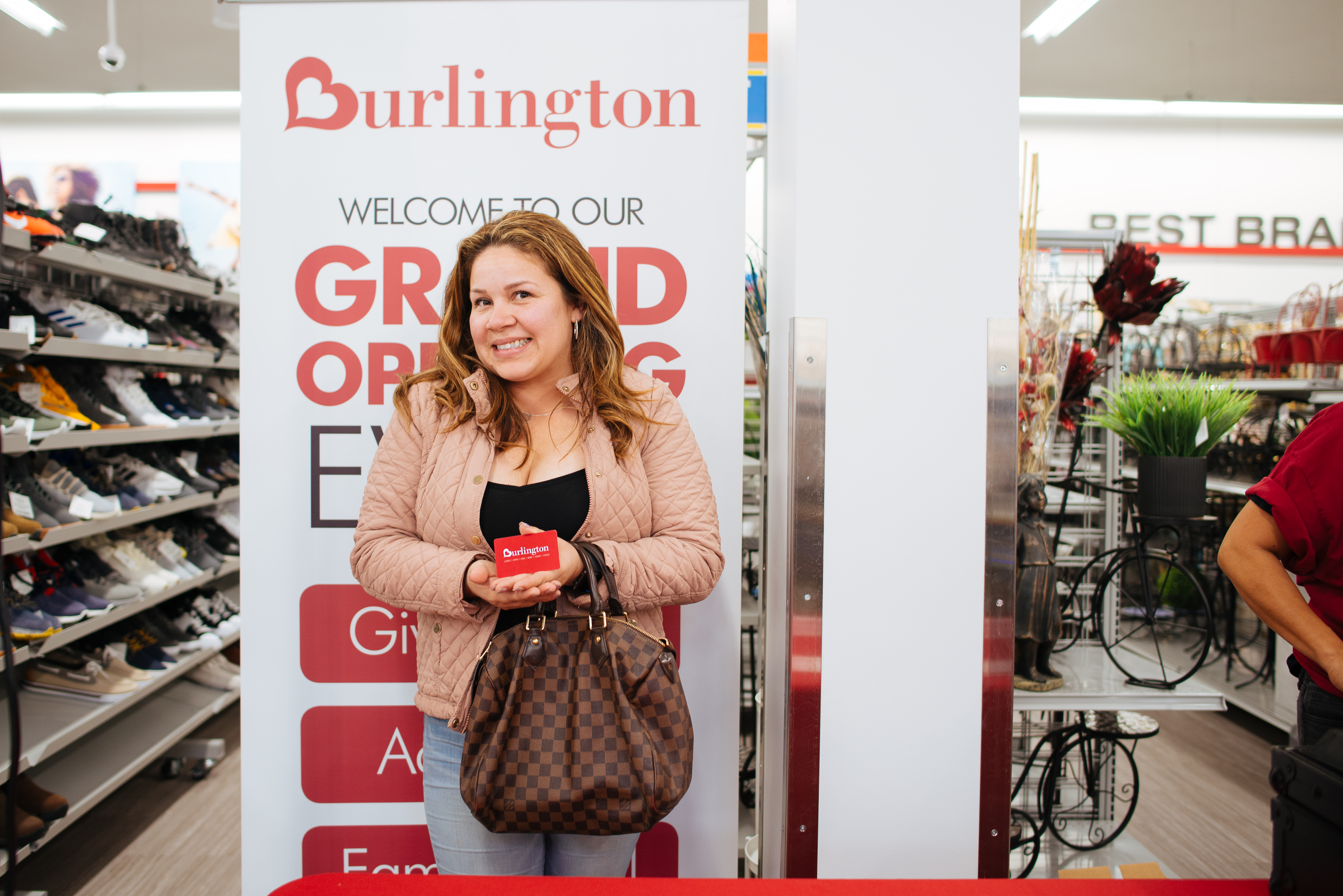 Woman smiling because she won a gift card for Burlington.